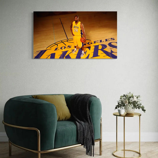 Lakers player in yellow jersey on a wall canvas above a green sofa with gold frame.