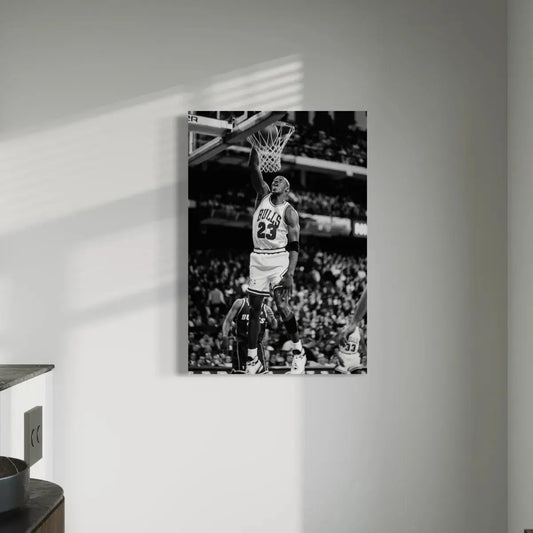 Monochrome canvas depicting Michael Jordan wearing his iconic #23 jersey, leaping towards the hoop for a high-flying dunk in a packed stadium.