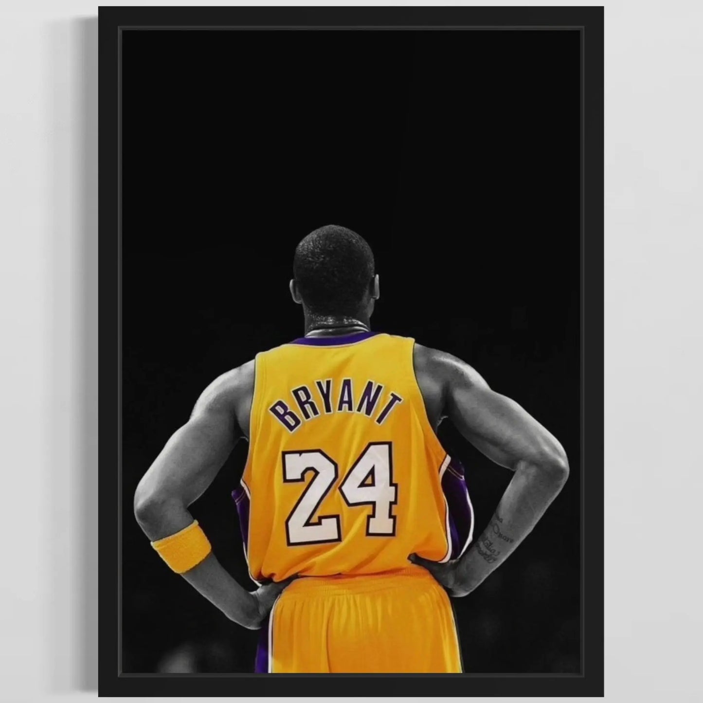 Framed poster of a basketball player in a yellow jersey with 'Bryant' and number '24' on a black background.
