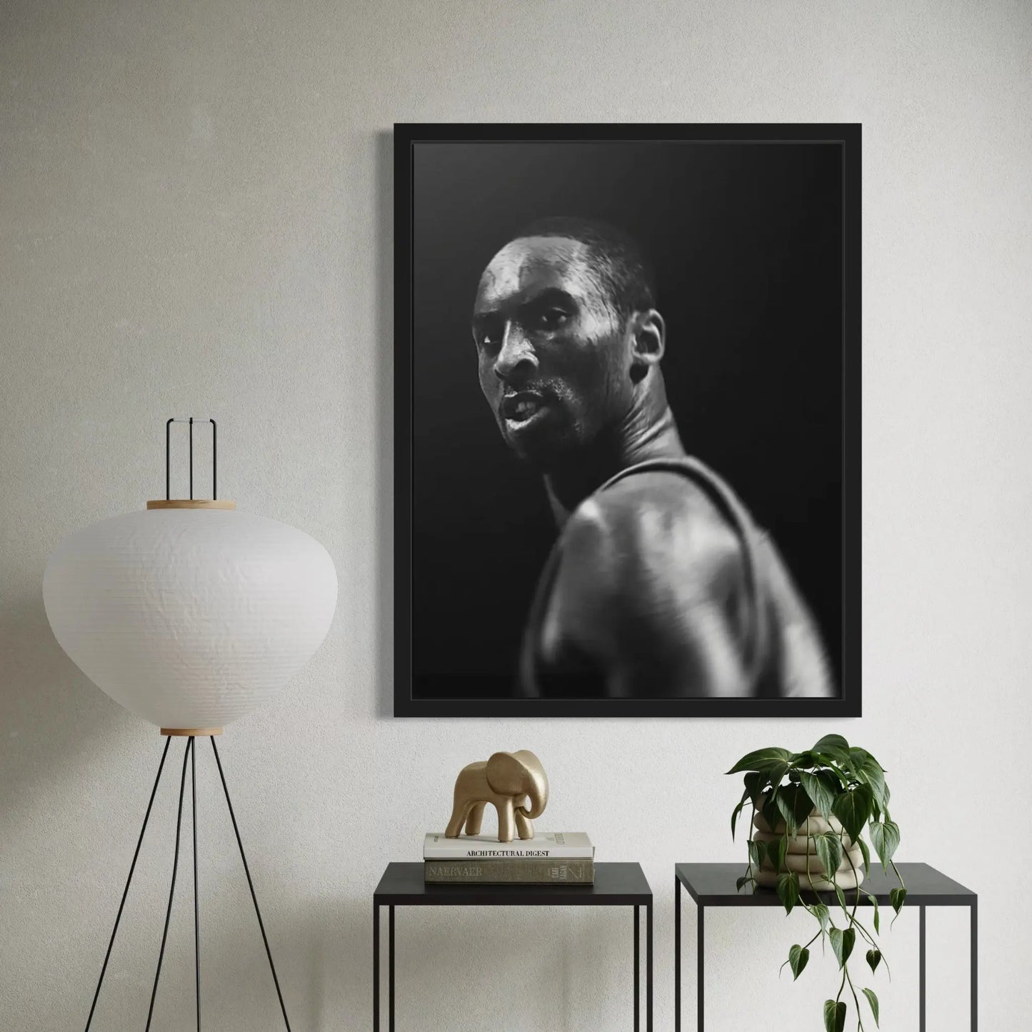 Framed black and white portrait of a man in a modern room with decor elements.