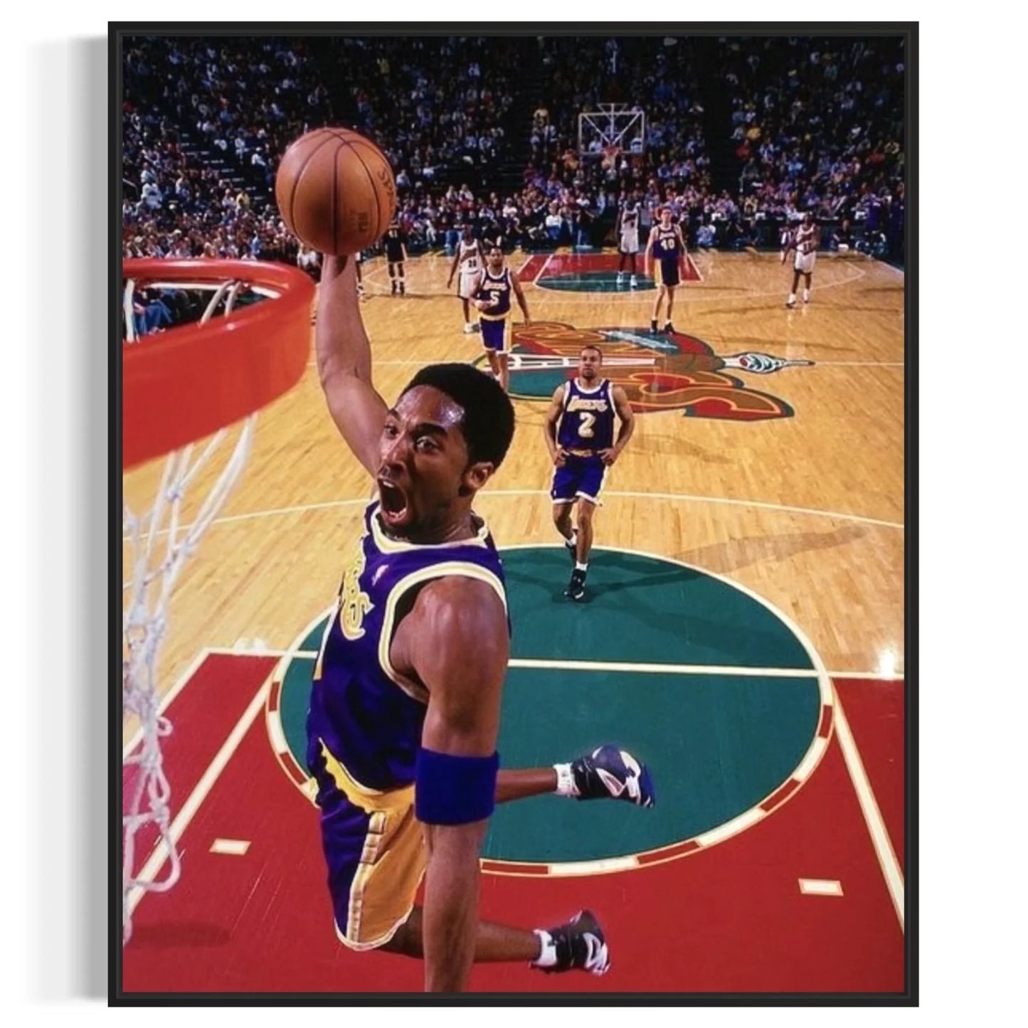 Framed wall art of Kobe Bryant flying toward the rim in his Lakers uniform.