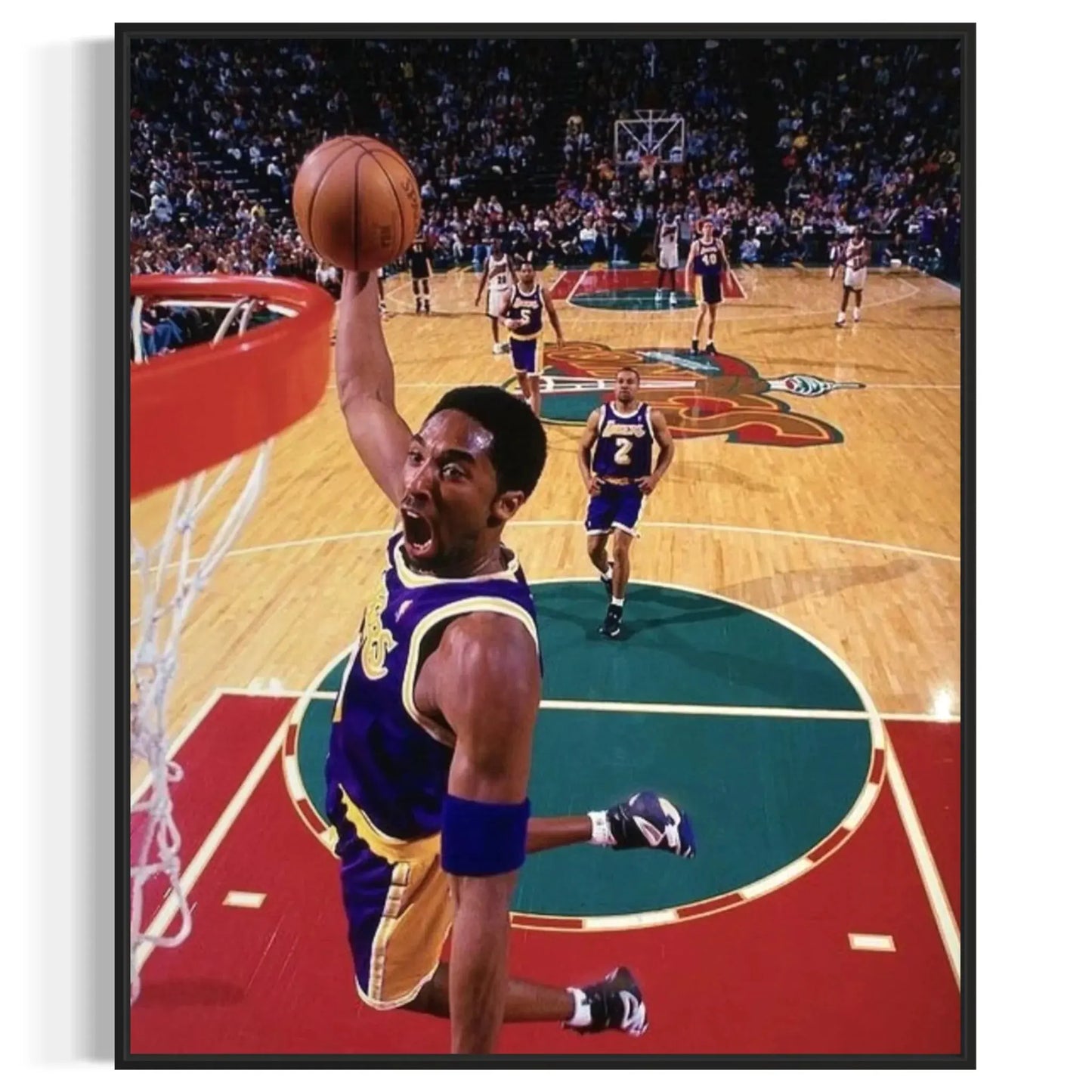 Framed wall art of Kobe Bryant flying toward the rim in his Lakers uniform.