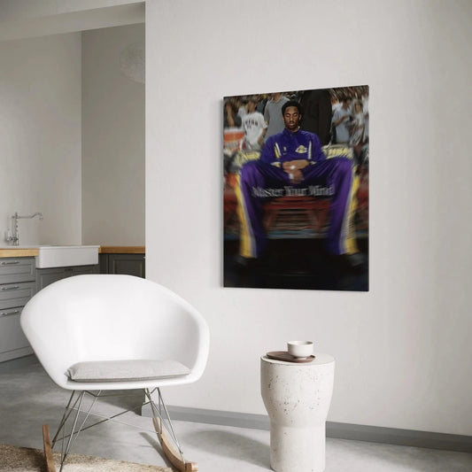 Modern interior with a white chair and small table, featuring a framed picture of a person in a purple outfit on the wall.