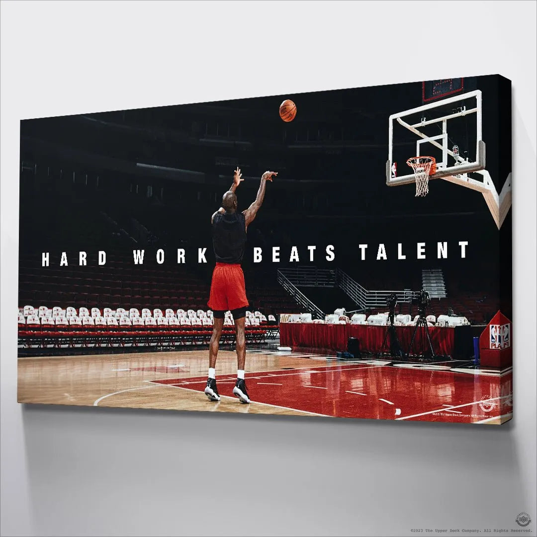 Rear view of Michael Jordan shooting a jump shot under the prominent 'Hard Work Beats Talent' text banner.
