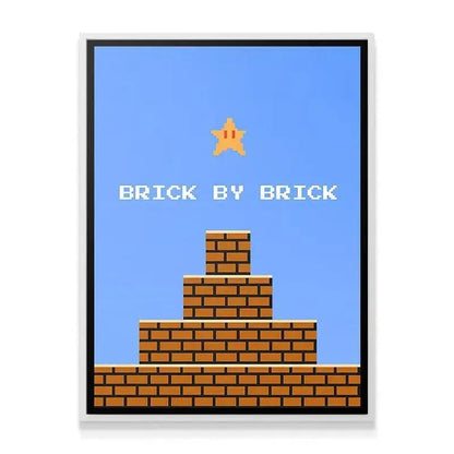 Lifestyle presentation showing the '8bit Brick By Brick' art hanging above a dedicated vintage gaming console setup.