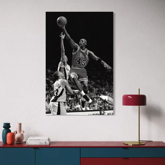 Black-and-white canvas print of Michael Jordan soaring for a dunk in his #45 Chicago Bulls jersey, captured mid-air during an NBA game.
