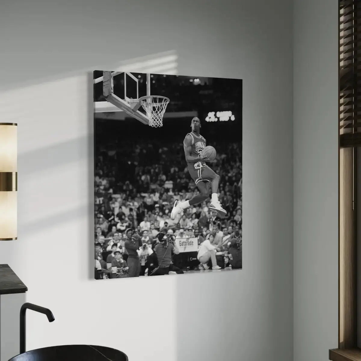 Monochrome canvas print showcasing Michael Jordan in mid-air dunk action with a minimalist wall-mounted display.