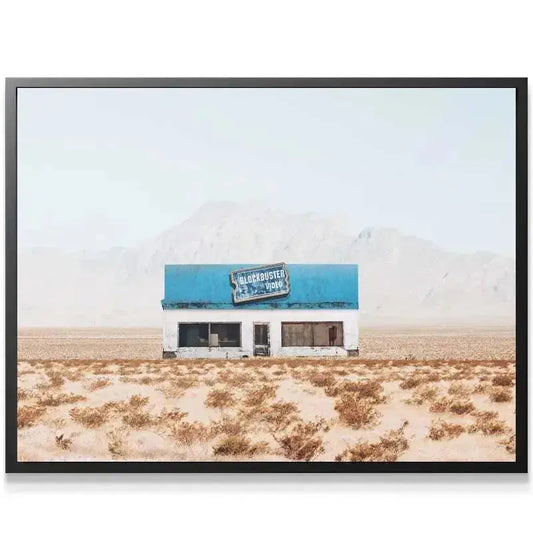 Close-up texture of the peeling blue paint and distressed signage defining the location of Abandoned Movies.