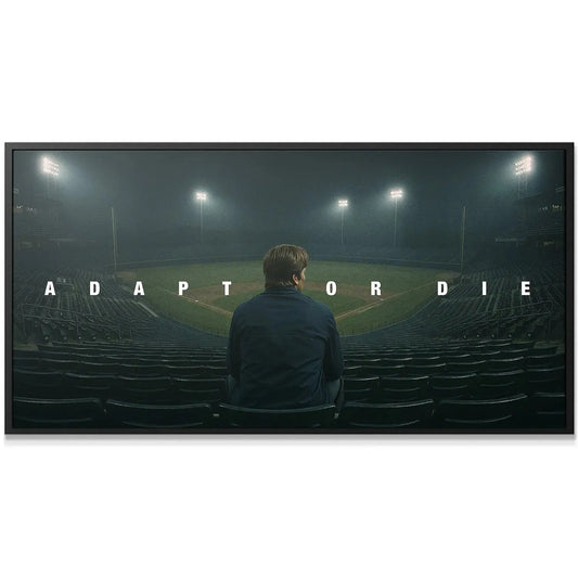 Detail view of the bold typography spelling out 'Adapt Or Die' illuminated by misty stadium lights.