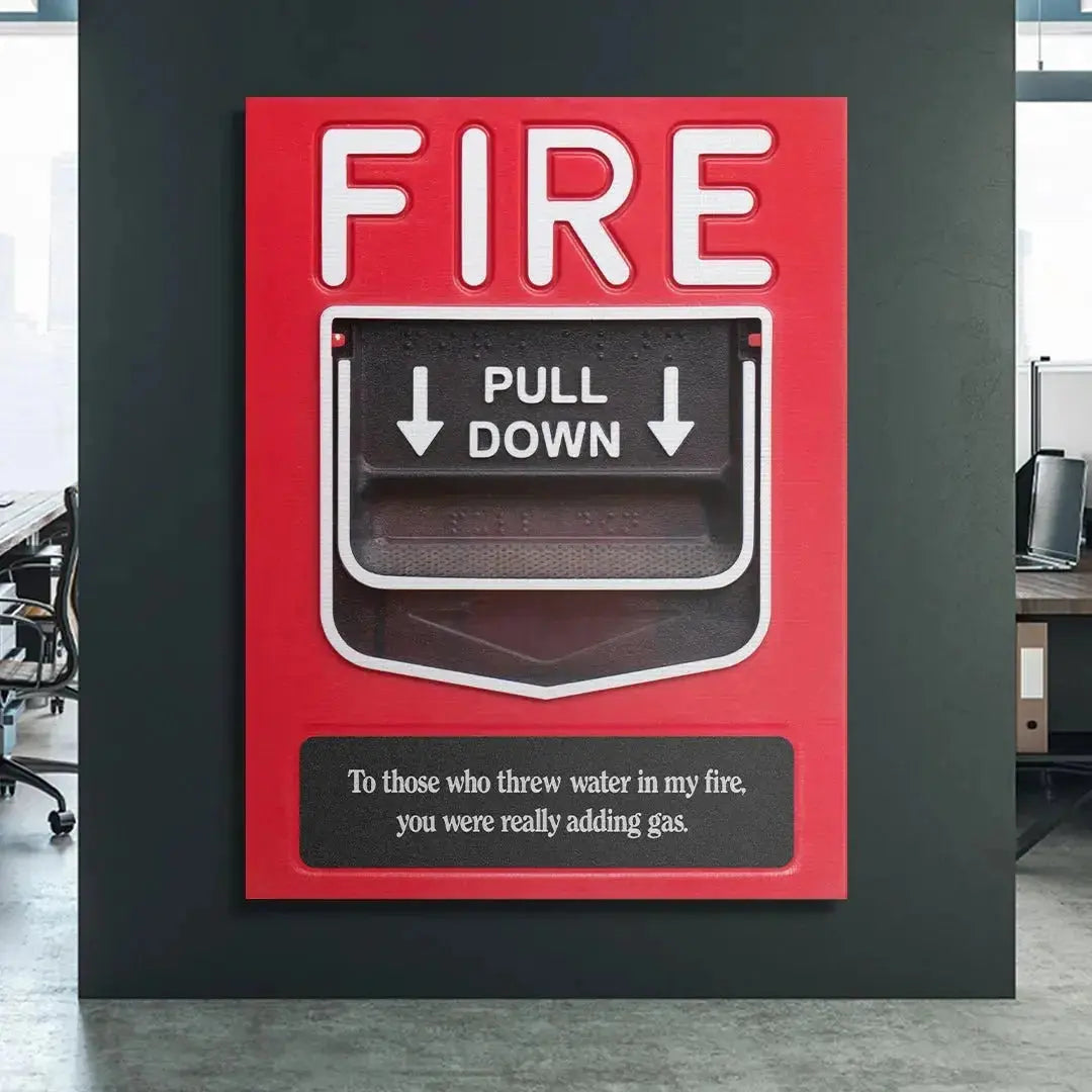 Lifestyle shot of the Add Gas fire alarm poster mounted prominently in a modern, minimalist office workspace for daily inspiration.