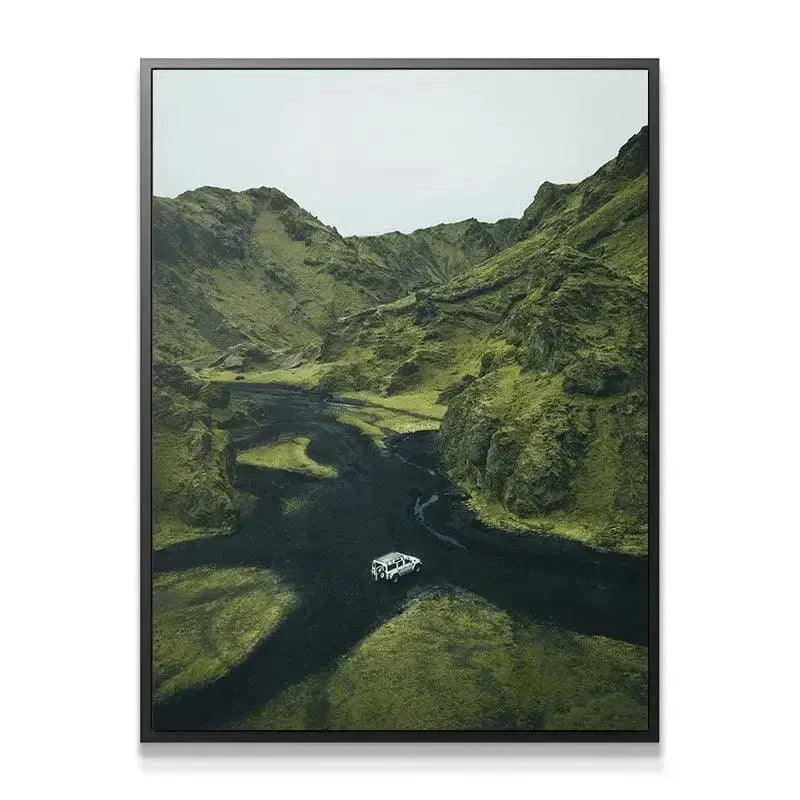 Close-up texture study of volcanic black sand contrasting vividly with deep green vegetation. Adventure Awaits.