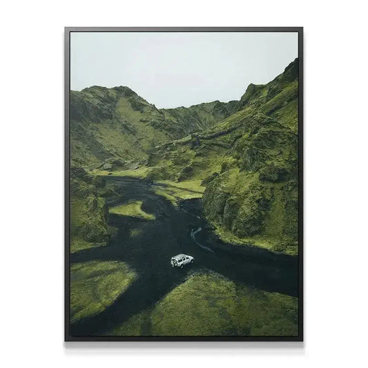 Close-up texture study of volcanic black sand contrasting vividly with deep green vegetation. Adventure Awaits.