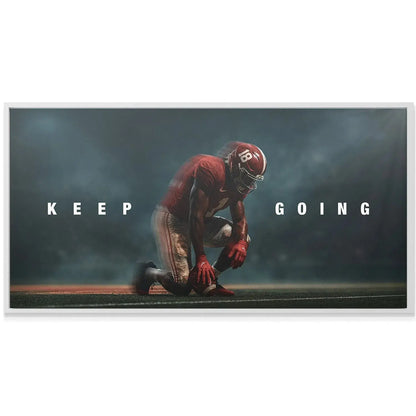 Texture detail of the synthetic turf beneath the athlete's cleats in the powerful 'Alabama - Keep Going' image.