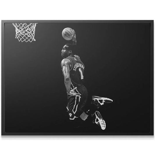 Close-up view of Amar'e Stoudemire - #4 focused on the face and Spalding ball during the dunk attempt.