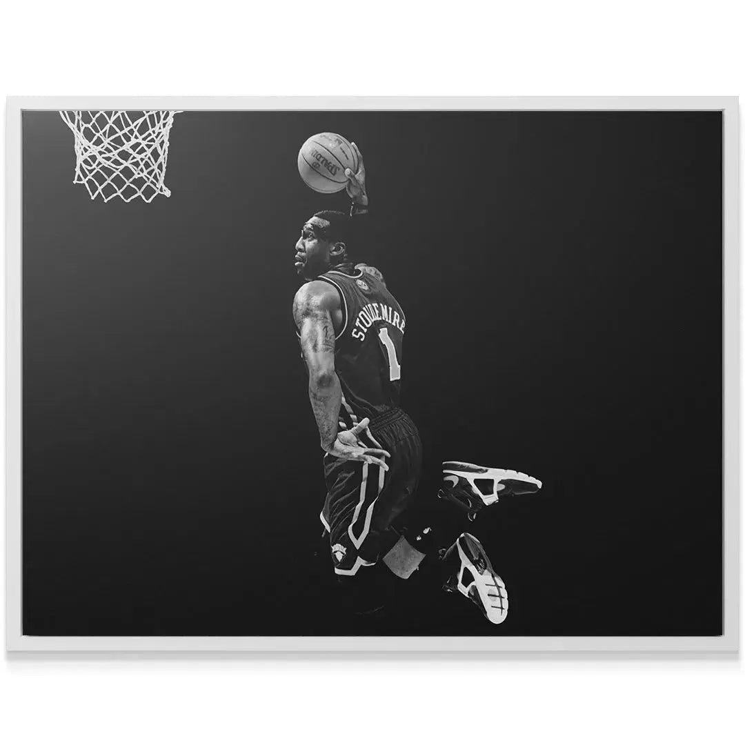 Low-angle perspective of the powerful dunk captured by Amar'e Stoudemire - #4 against a clean, dark background.