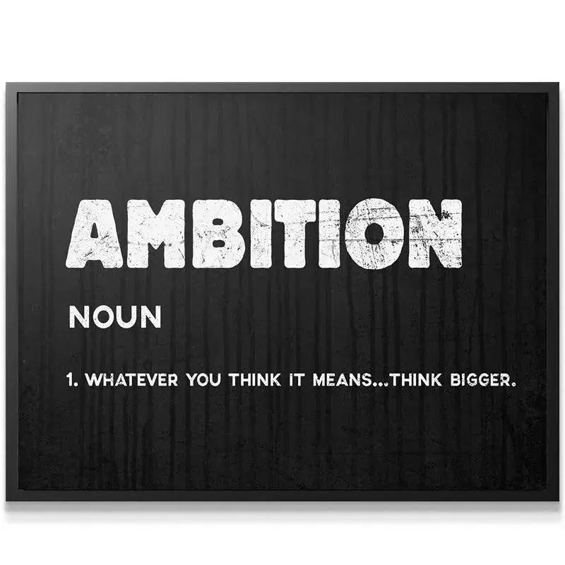 Wide shot of the Ambition poster mounted above a modern minimalist desk in a home office setting.