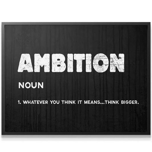 Wide shot of the Ambition poster mounted above a modern minimalist desk in a home office setting.