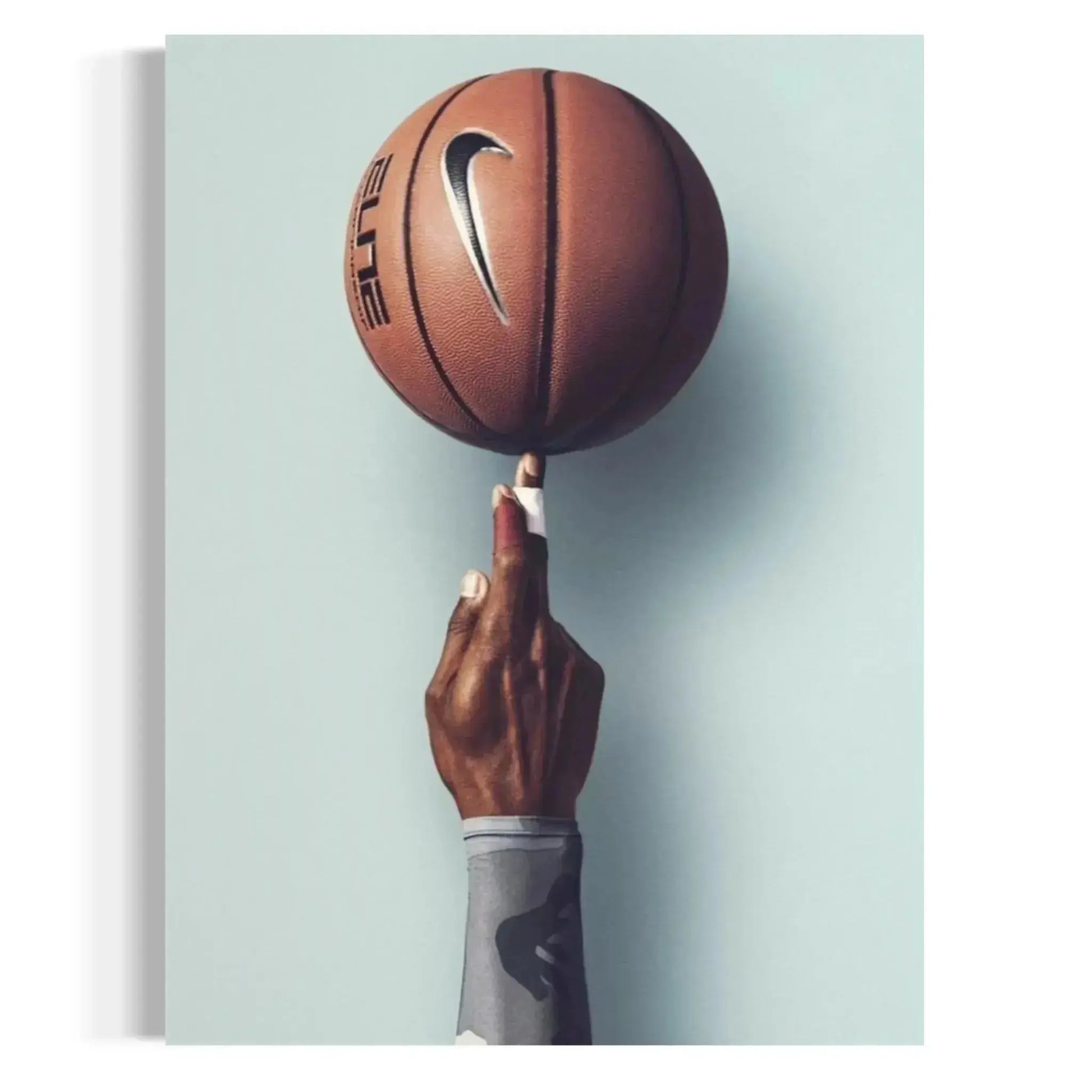 Close-up of textured basketball spinning on a fingertip, captured in the Basketball Wall Art – Modern Sports Print for Dynamic Interiors.
