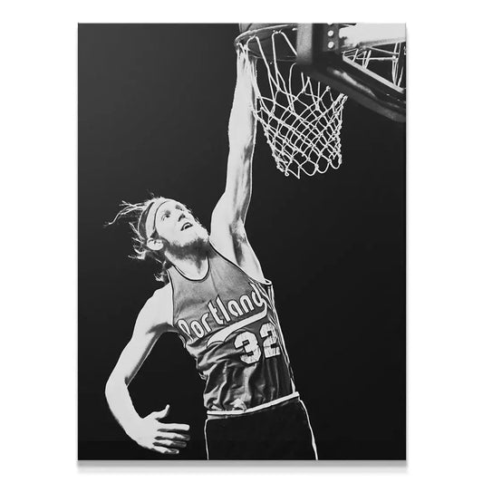 High-contrast close-up shot of Bill Walton - #2 executing a powerful slam dunk in black and white.