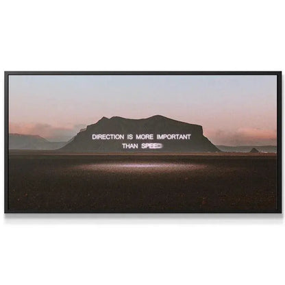 Close-up detail of the neon-style lettering stating 'Direction is More Important than Speed' artwork.