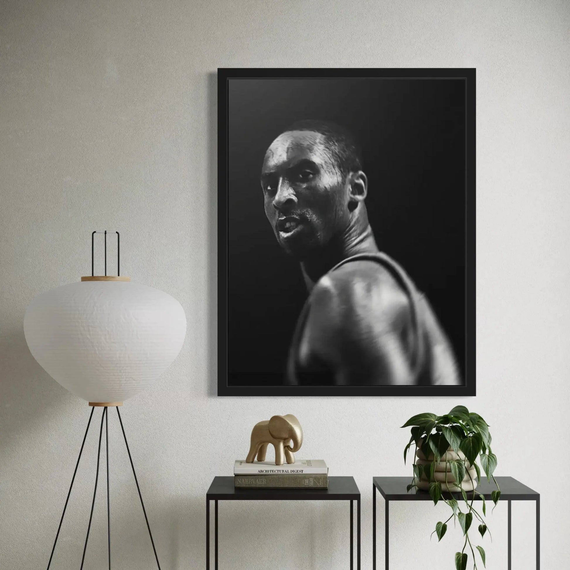 Framed black and white portrait of a man in a modern room with decor elements.
