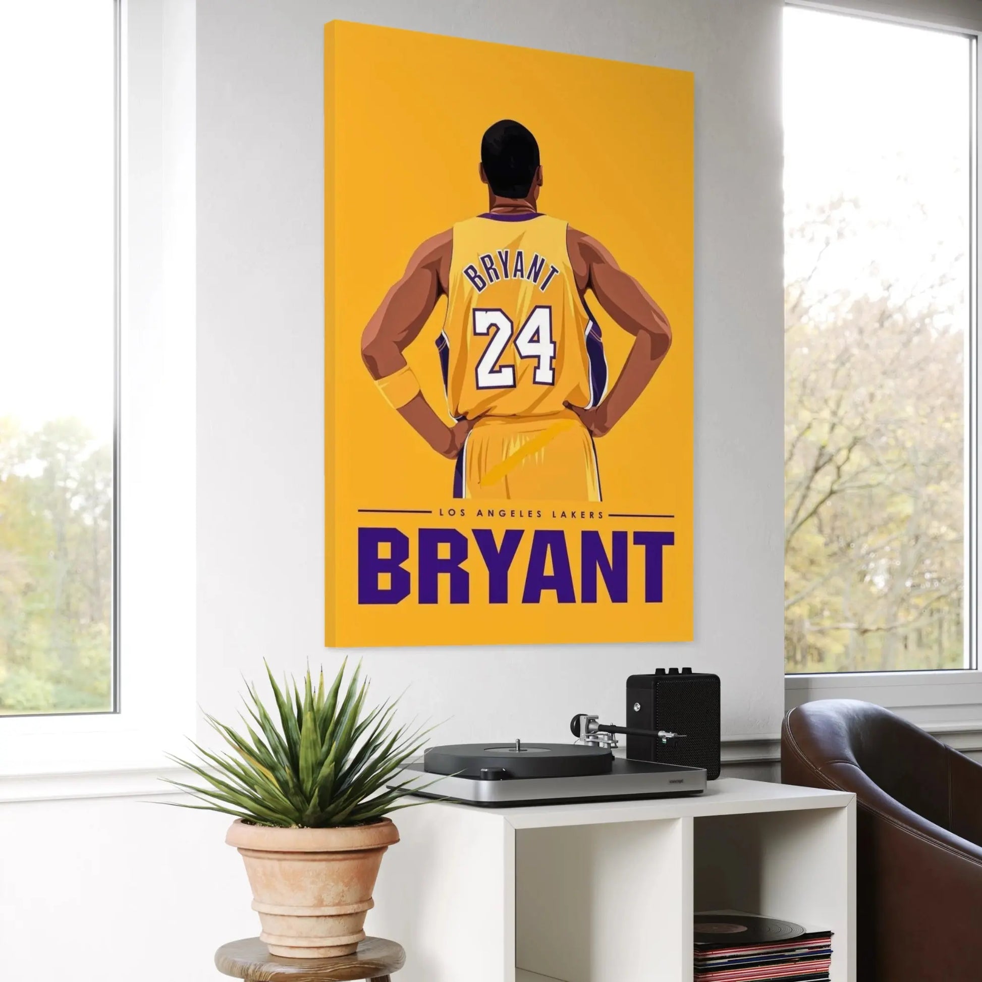 Canvas print of a basketball player in a yellow jersey with 'Bryant' on a yellow background, displayed in a room with a window and plant.