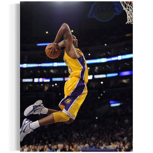 Basketball player in a yellow and purple uniform dunking a ball during a game.