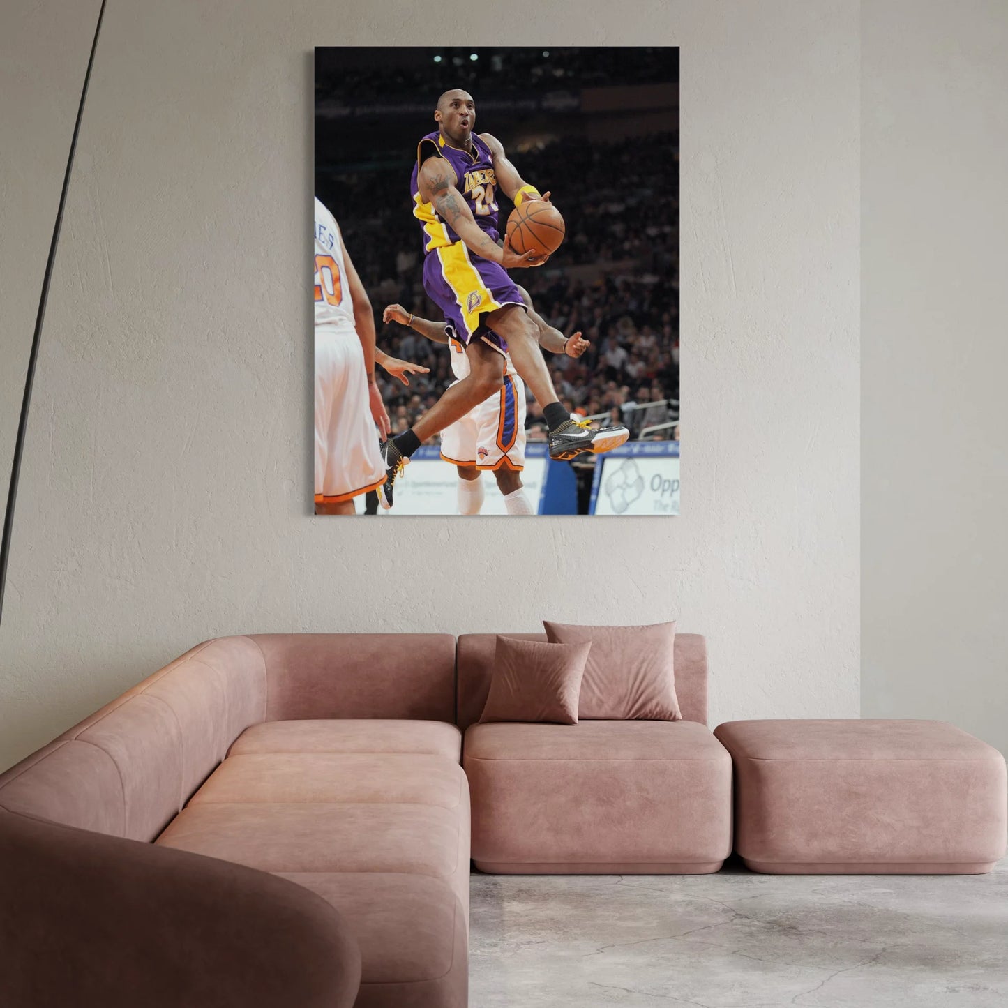 Framed wall art of Kobe Bryant mid-air during a game, wearing Lakers purple and gold.