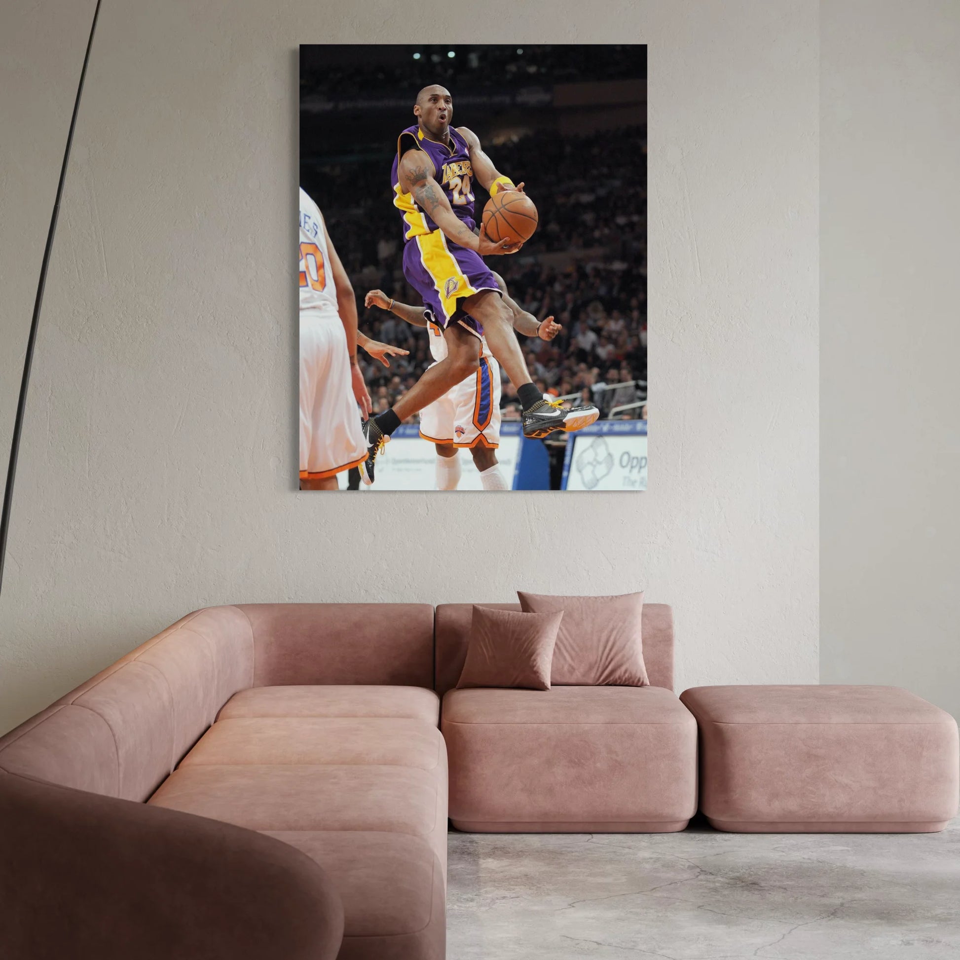 Framed wall art of Kobe Bryant mid-air during a game, wearing Lakers purple and gold.