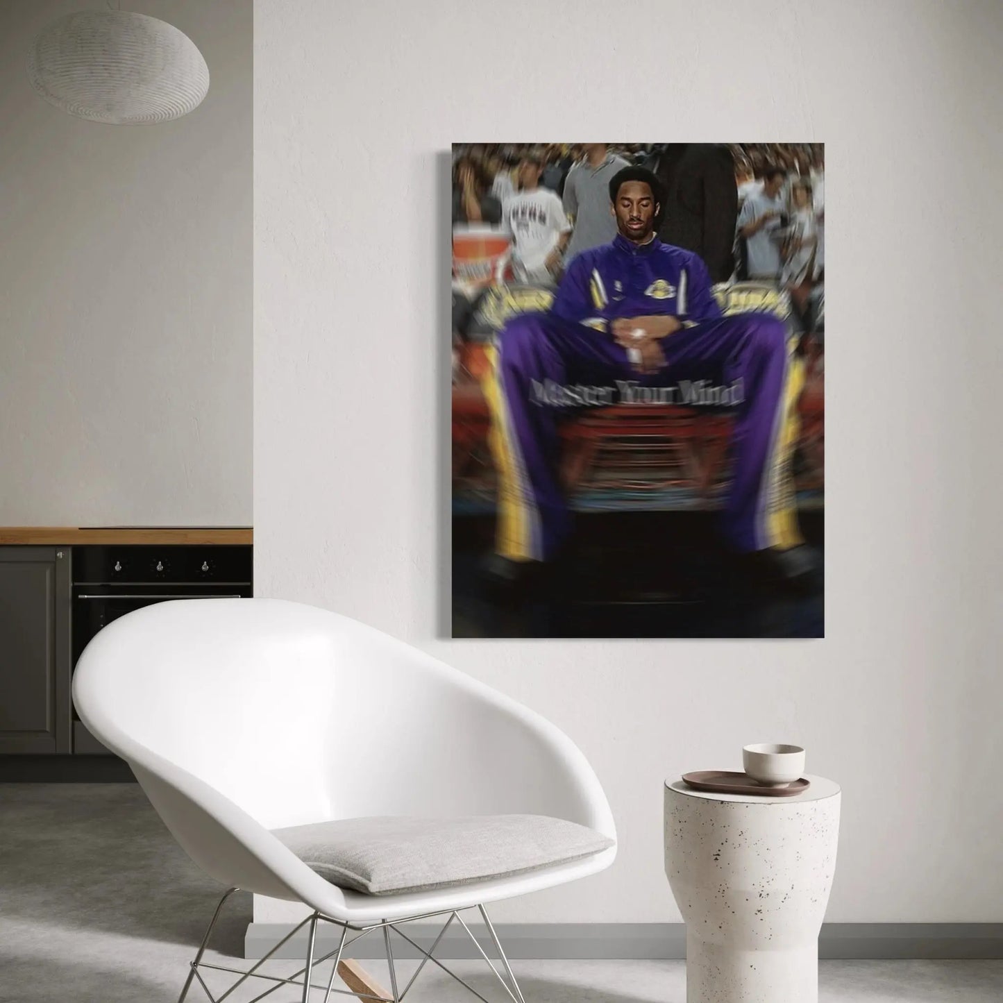 Living room with a white chair, small table, and a framed picture on the wall.