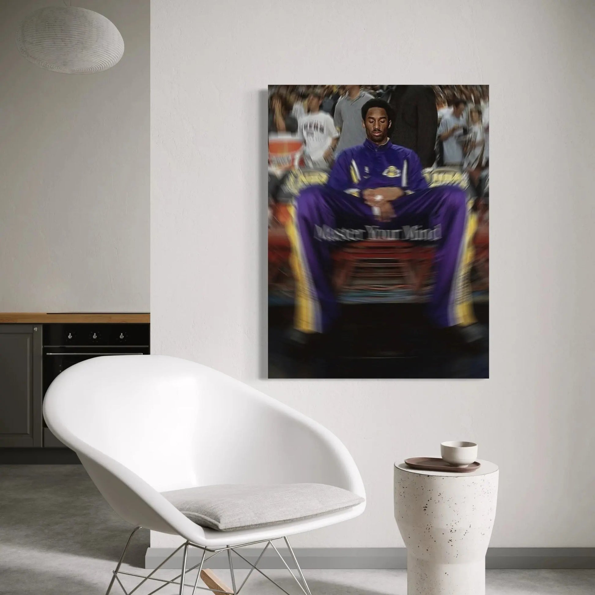 Living room with a white chair, small table, and a framed picture on the wall.