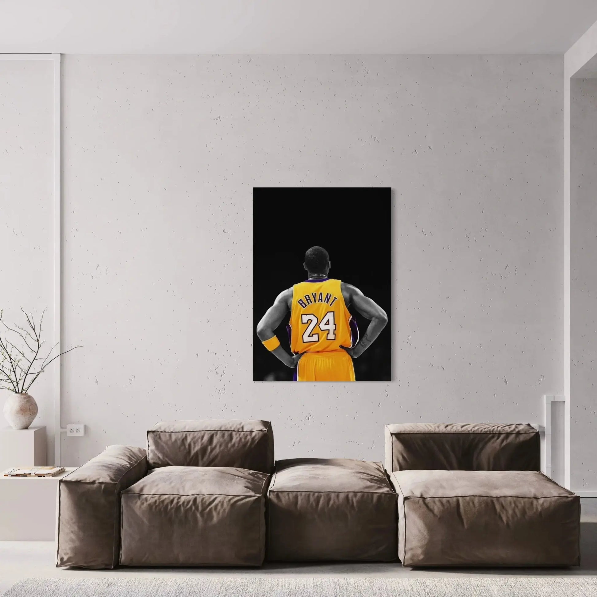 Framed artwork of a basketball player in a yellow jersey hanging on a wall above a sofa.