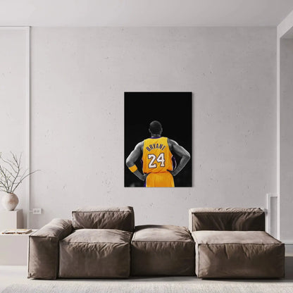 Framed artwork of a basketball player in a yellow jersey hanging on a wall above a sofa.