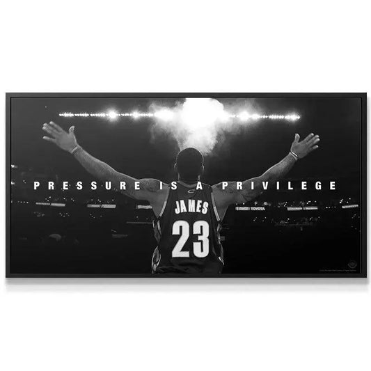 Wide-angle shot of the basketball arena crowd and bright lights surrounding the "LeBron James - Pressure Is A Privilege" print.
