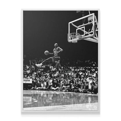 Wide-angle shot emphasizing the reflective court floor and spectators beneath the action captured in "Michael Jordan - Frozen In Time."