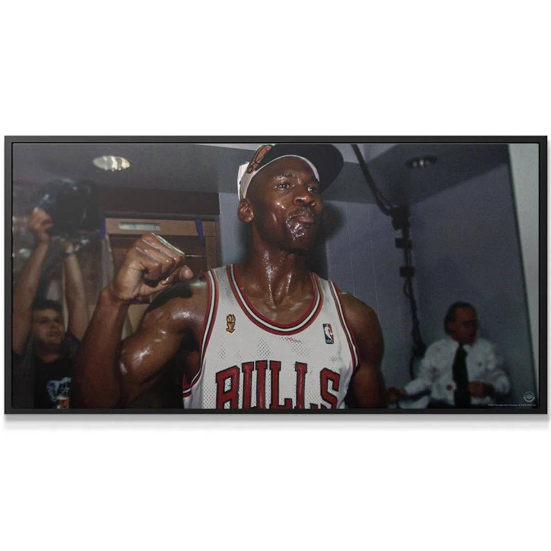 Wide shot emphasizing the surrounding dark, victorious locker room atmosphere captured in 'Michael Jordan - Nothing Worth Having Comes Easy'.