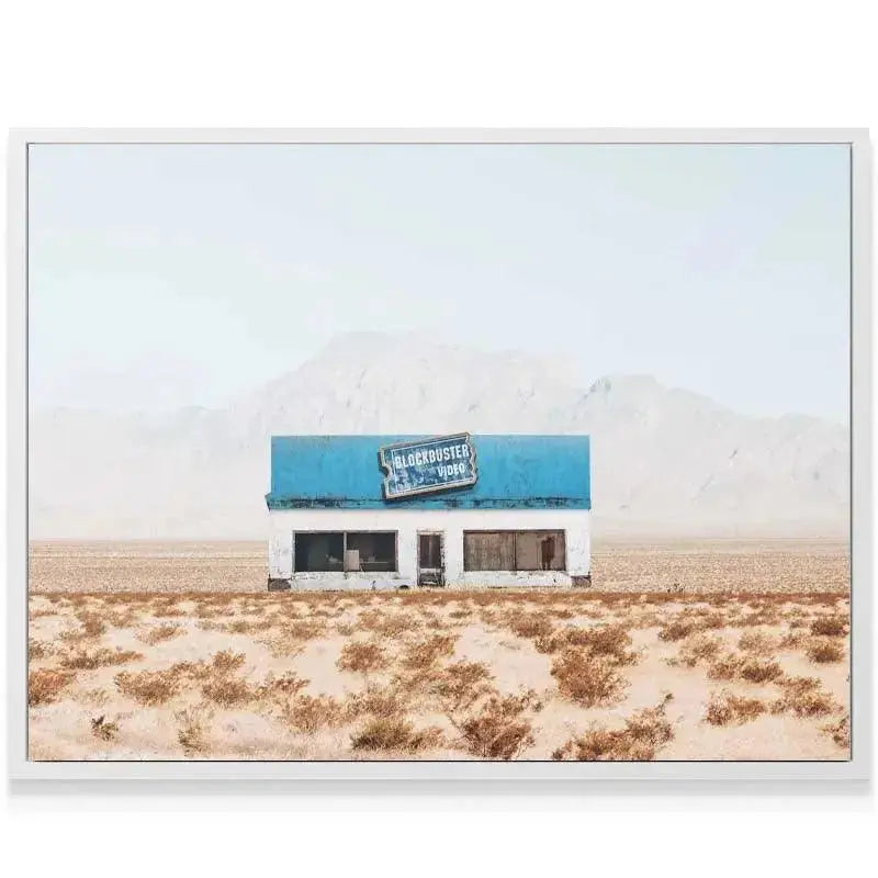 Mid-distance shot showing the contrast between the dry desert brush and the building of Abandoned Movies.