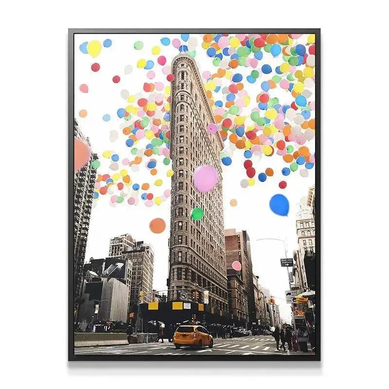 Low angle street view showing the vibrant red, blue, and yellow spheres rising in Balloon City artwork.