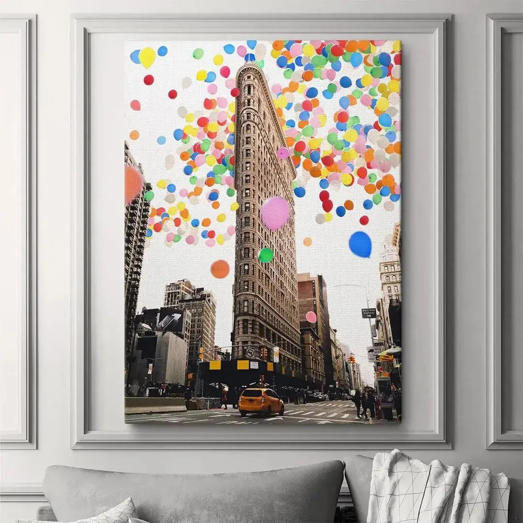 Wide shot featuring a yellow taxi driving beneath the whimsical Flatiron Building scene of Balloon City artwork.