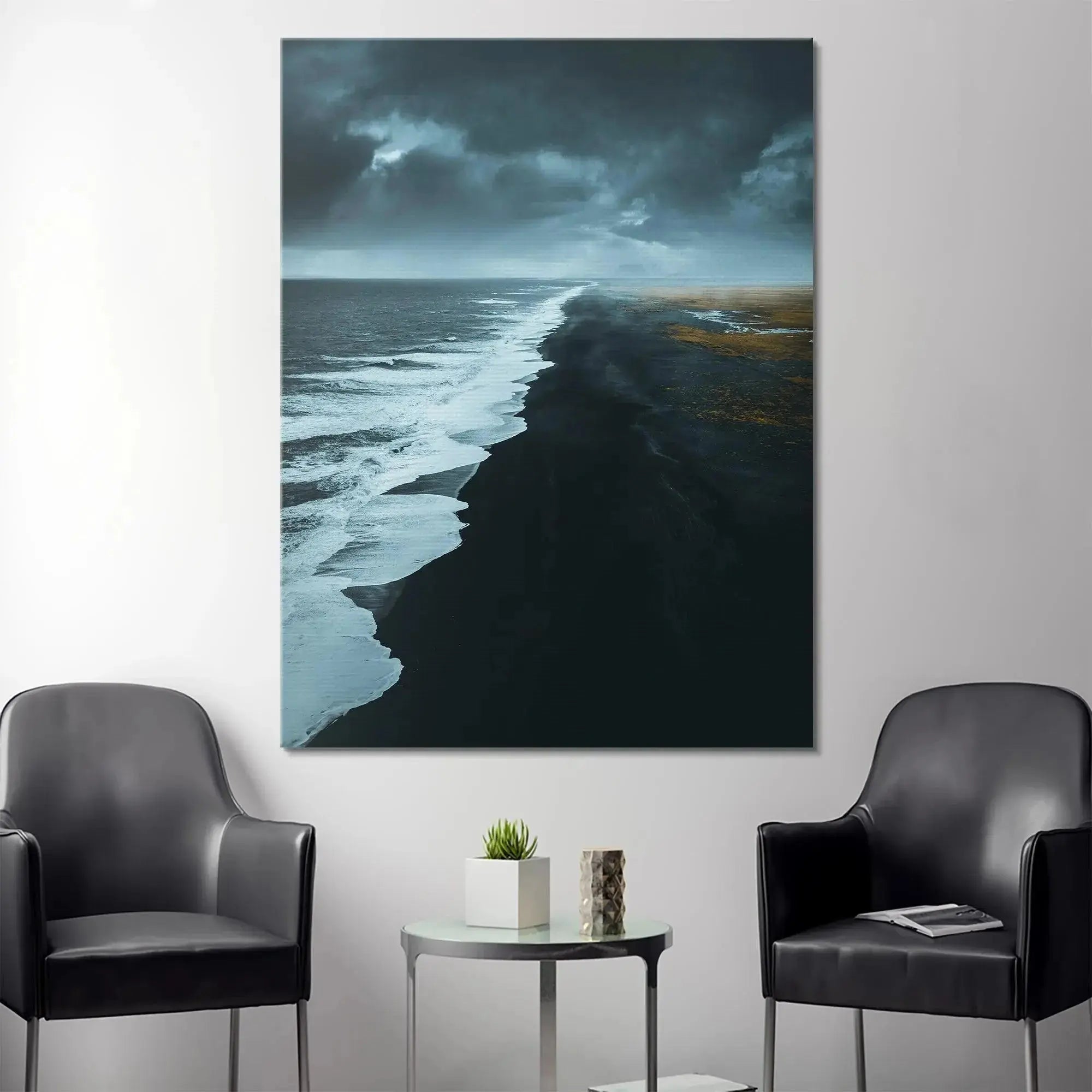 Dramatic high-angle perspective emphasizing the intense boundary where the powerful ocean waves meet the Black Beach.