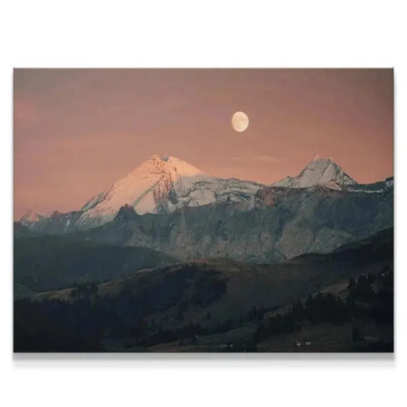 Panoramic view of snow-capped mountains under the Blood Moon at dusk