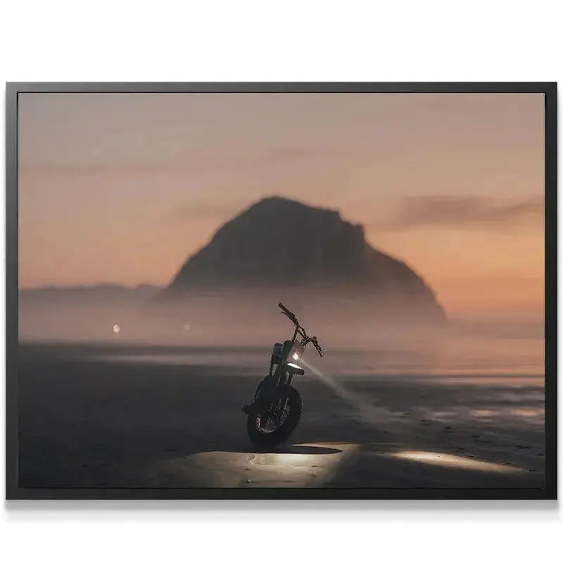 Wide shot view of Morro Rock looming over the solitary e-bike during the Blue Hour Morro sunset.