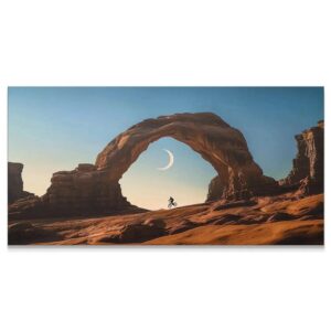 Wide-angle desert scene capturing the dramatic natural rock arch and cyclist silhouette, BMX -1.