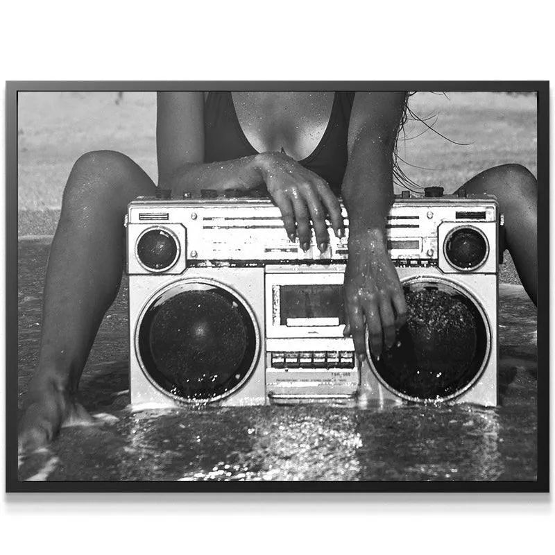 Close-up on the wet hands resting on the top controls of the Brooklyn Boombox.