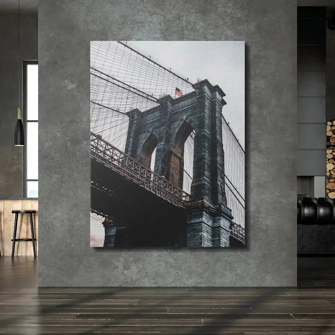 Upward perspective showcasing the gothic arches of the historic Brooklyn Bridge.