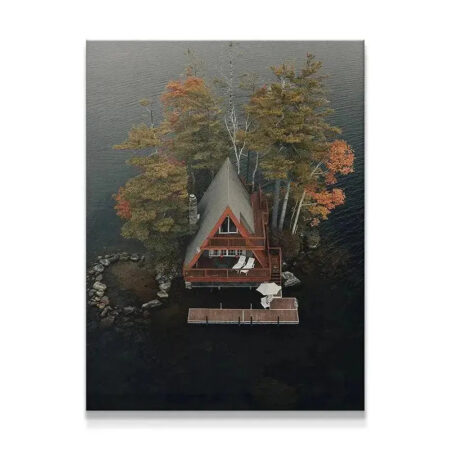 Aerial view of A-frame 'Cabin Love' dwelling situated on a misty, dark lake peninsula.