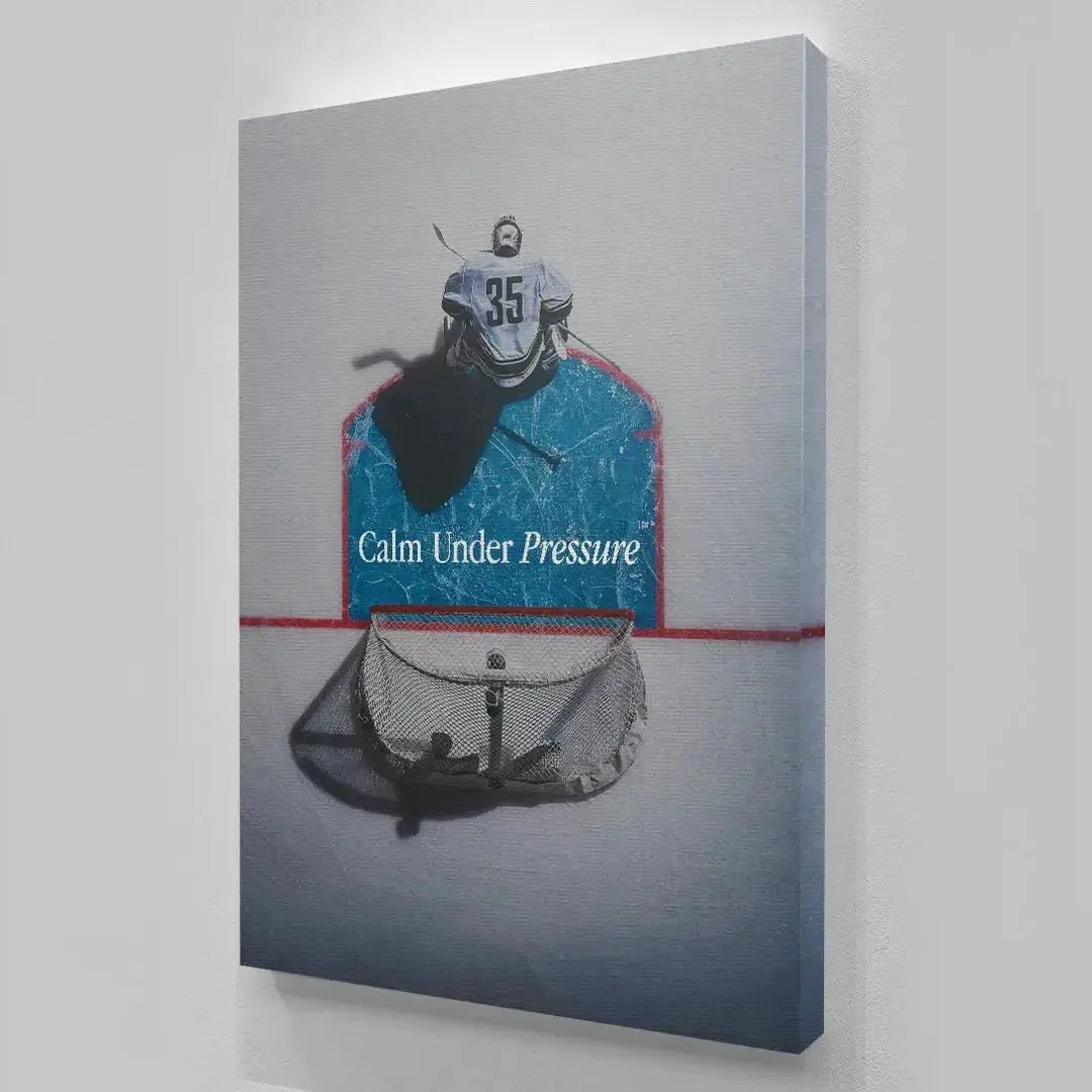Lifestyle mockup showing the framed print 'Calm Under Pressure (Hockey)' hanging in a minimalist office setting.