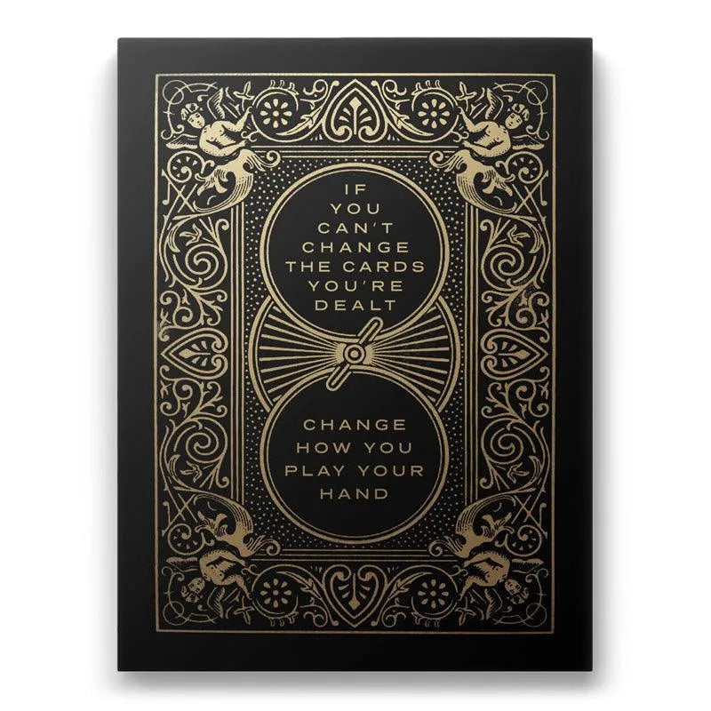 Full front view of the motivational print 'Cards You’re Dealt' featuring black matte and shining gold foil stamping.