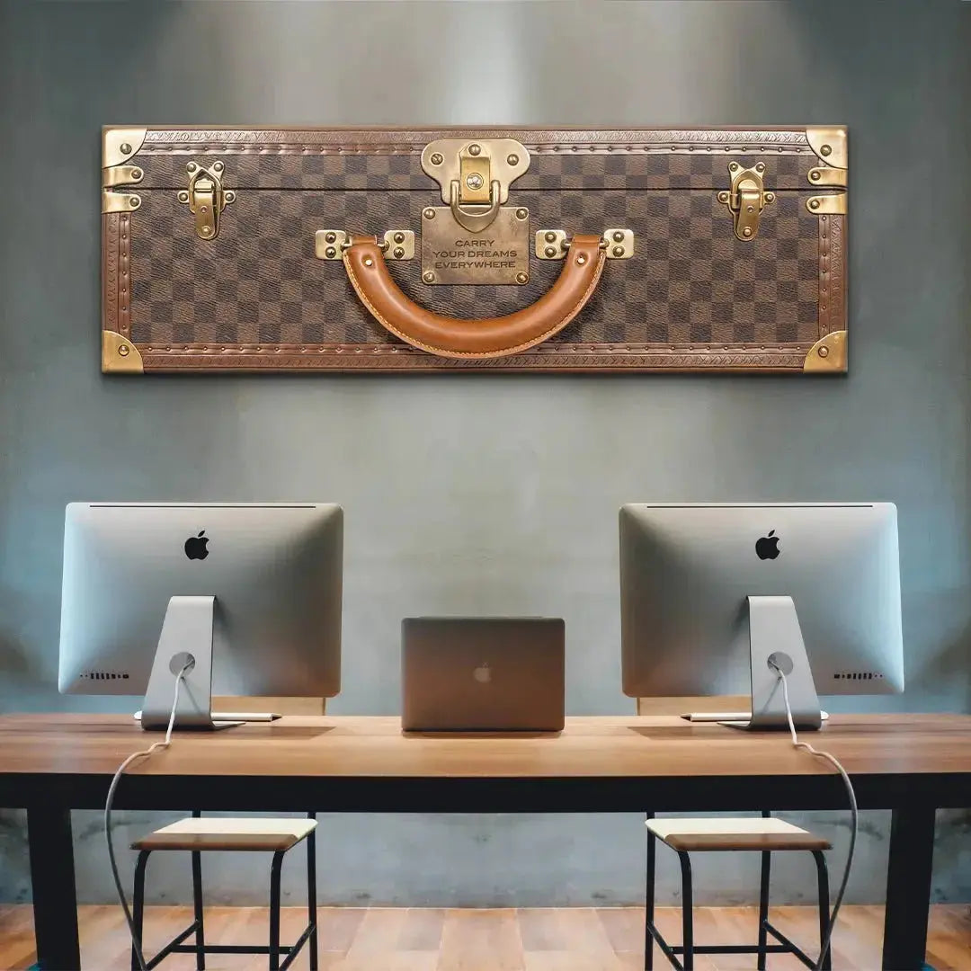 Texture detail of the brown leather handle and brass rivets on the decorative trunk; robustly built to Carry Your Dreams Everywhere.