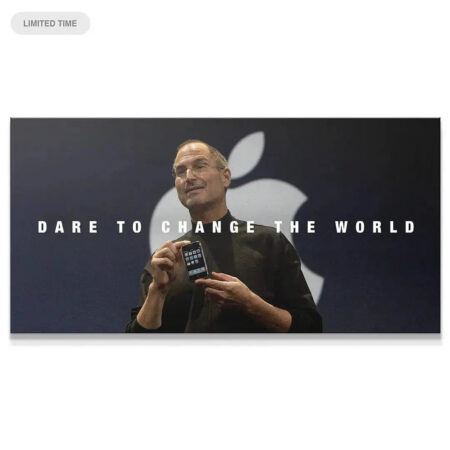 Wide shot of Steve Jobs holding the iPhone prototype, emphasizing the 'Dare to Change the World' text on the black background.